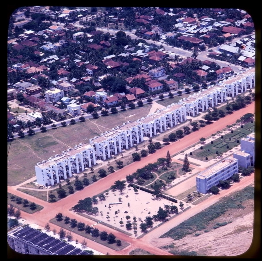 Archive colour photo of a long white apartment building.