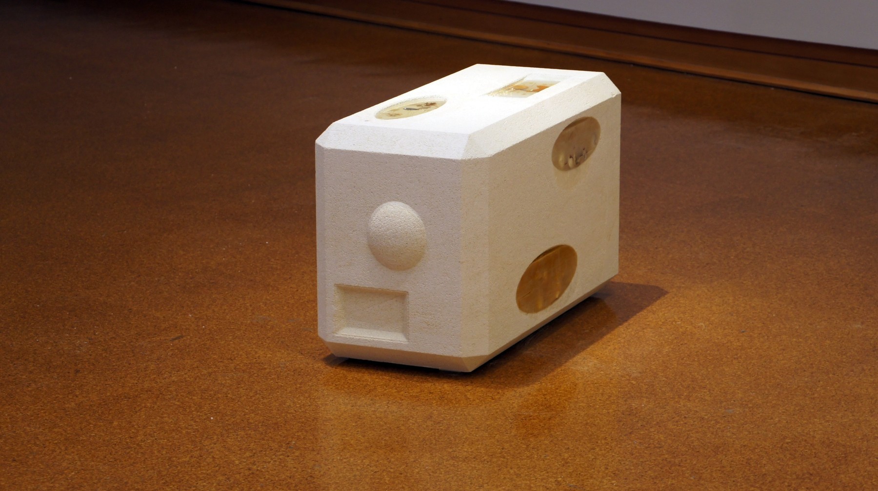 A white cast speaker with objects embedded