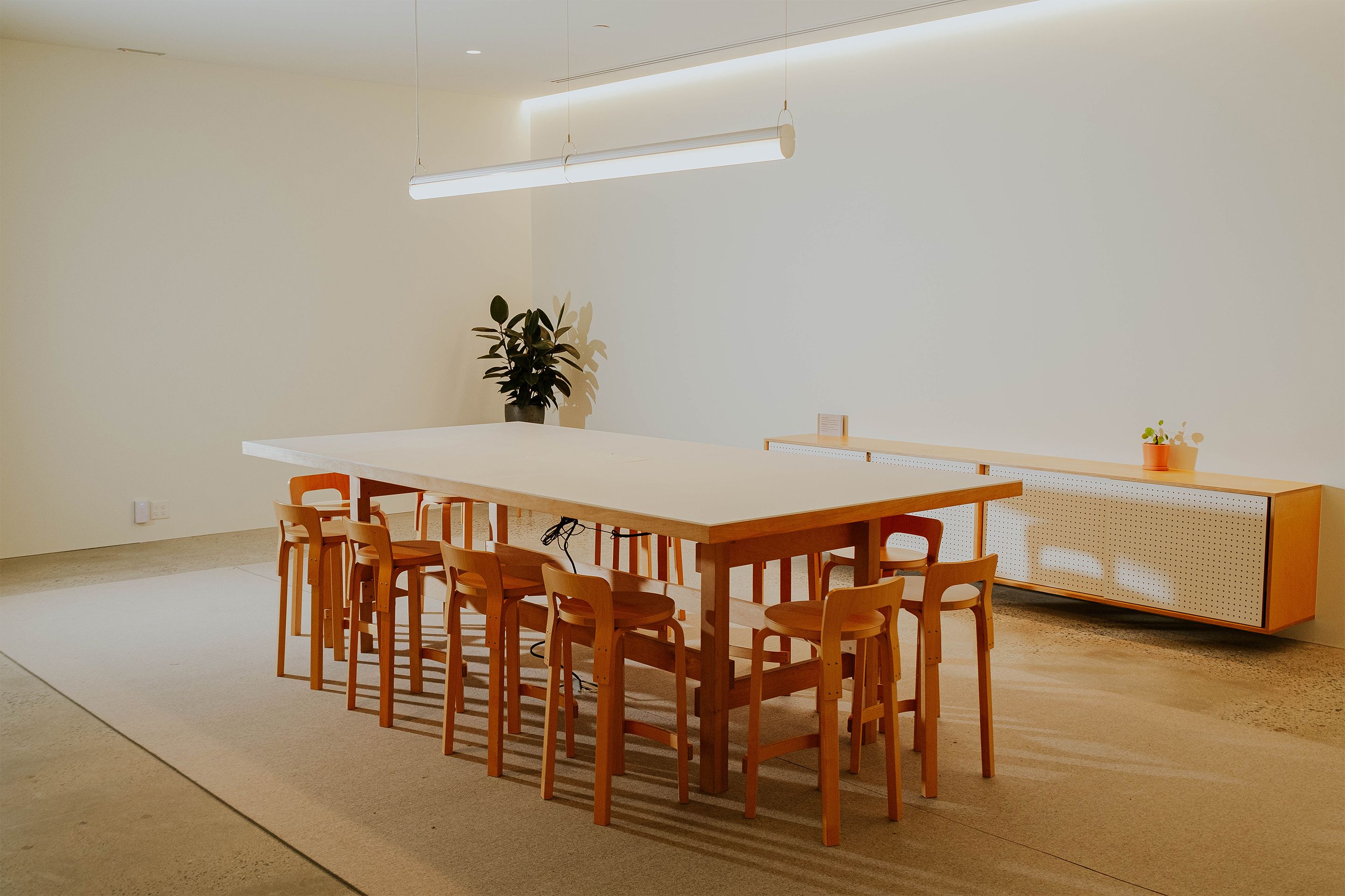 RBW Factory conference room with large conference table and Queue pendant