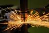 The spot welder is welding the nut on the metal part