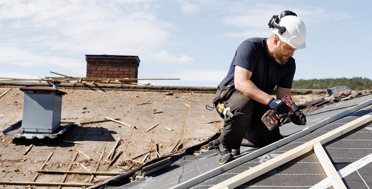 Håndverker monterer nytt tak på enebolig under takbytte
