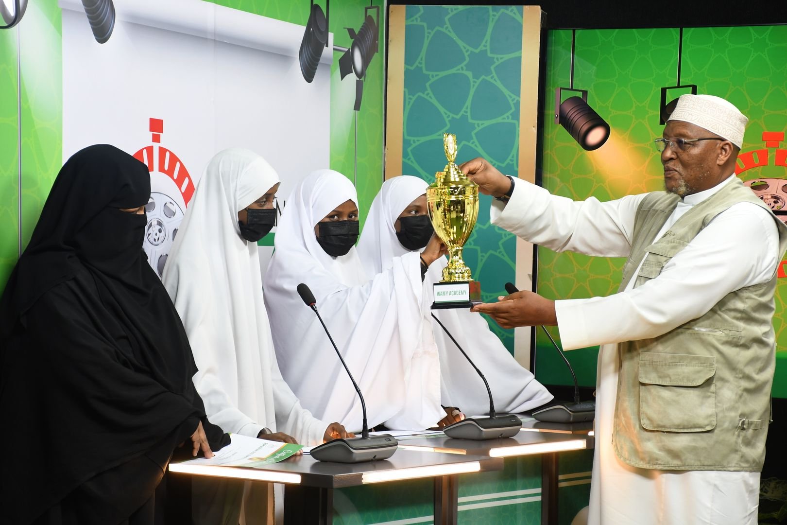 Sheikh Ibrahim Lethome presents the trophy to the overall winners, WAMY Academy Girls