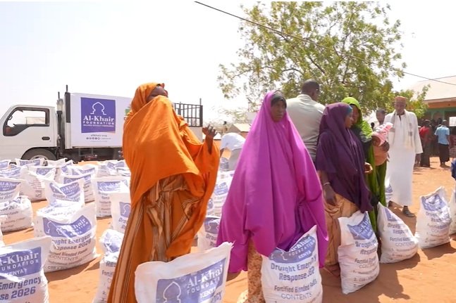 People receive food aid at a distribution centre in Mandera