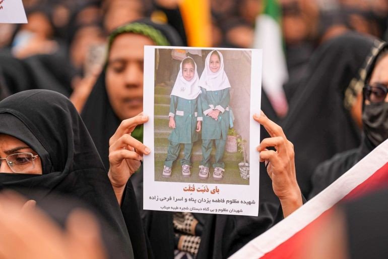 Mourners hold a portrait of a students during a funeral ceremony for children, who lost their lives after a primary school in Iran’s Hormozgan province was targeted in US and Israeli attacks, on March 03, 2026 in Minab, Iran 