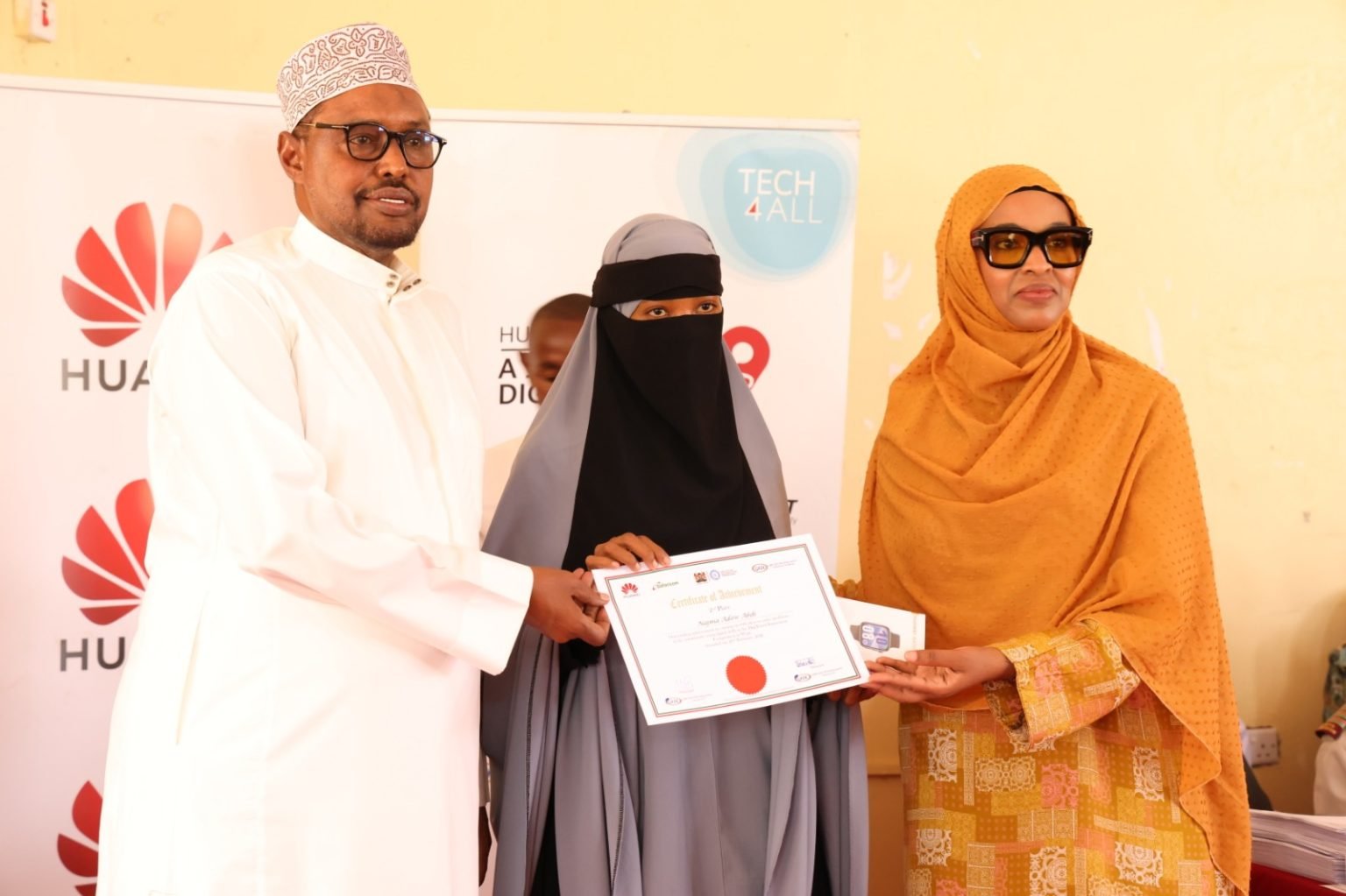 Wajir East MP, Aden Daudi (left) digital trainee Najma Adow Abdi (centre) and State Department for Culture, the Arts & Heritage, PS Ummi Bashir (right) during the Huawei DigiTruck graduation ceremony