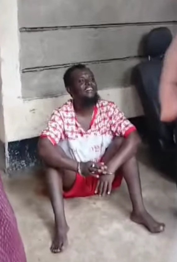 In handcuffs: The suspect shortly after he was arrested