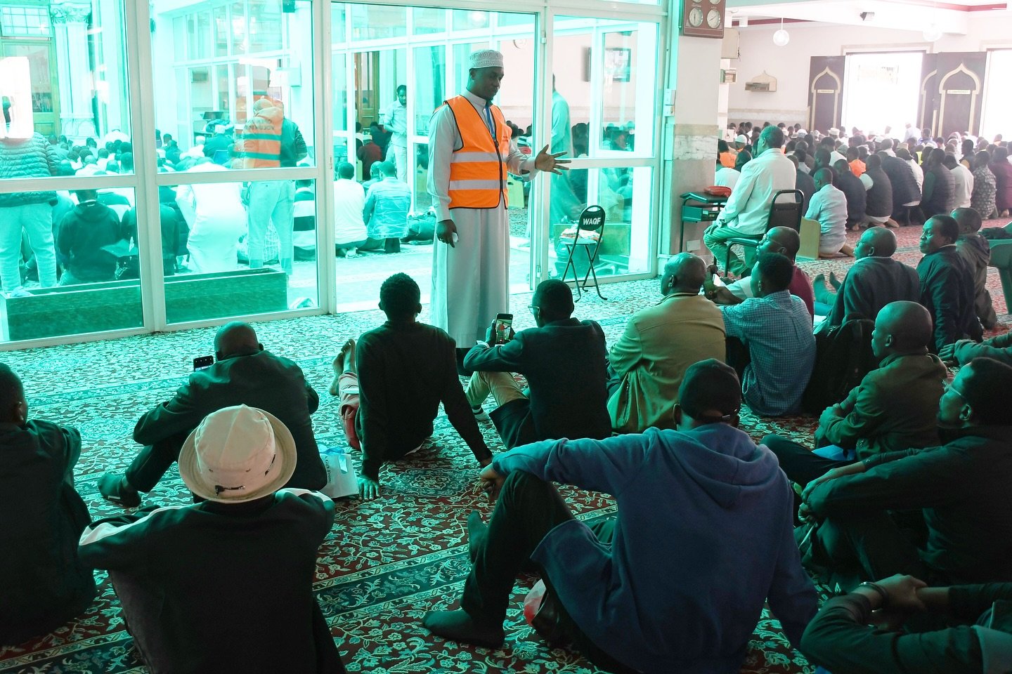Sheikh Ratib Abdunoor, the Da'wah officer of Jamia mosque explains to the non-Muslims visitors details about the Islamic prayer.