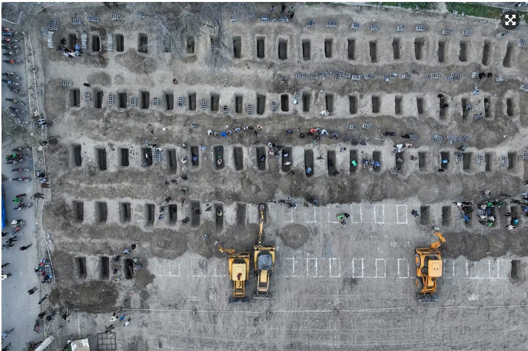 Mourners dig graves during the funeral for more than 140 children killed in a US attack on a primary school in Minab in Iran's Hormozgan province.