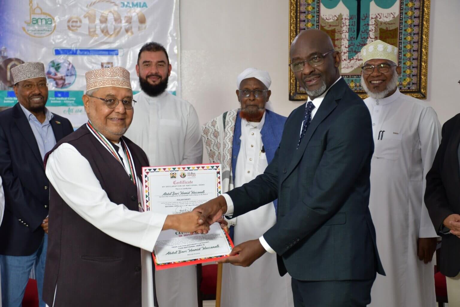 The Jamia Mosque Secretary General receives a certificate of award from the National Heroes Council CEO Charles Wambia