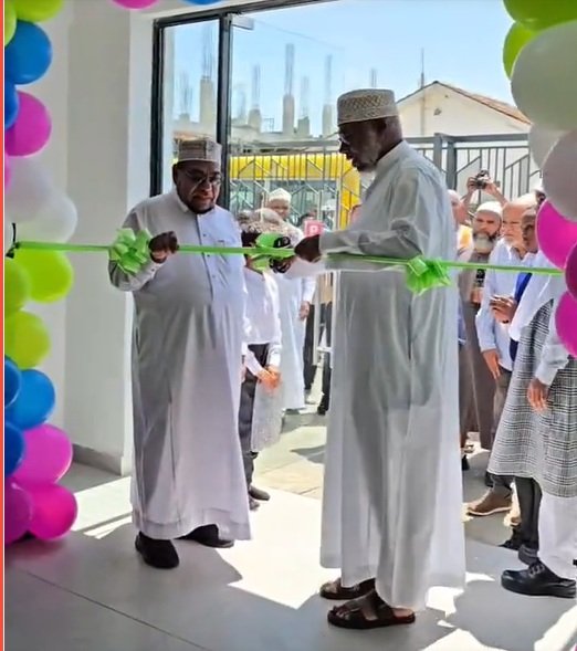 Jamia Mosque Vice chairman Abdullatif Essajee (right) cuts the tape to officially open Al Ameen Academy, South C branch. He is accompanied by Islamic scholar Sheikh Suleyman Shaqsy
