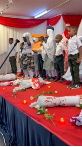 Pupils of Muslim Academy, Park Road display baby shrouds to represent the children of Palestinians killed during the Israeli genocide
