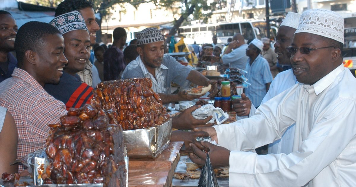 People buy dates at a street market in Mombasa. Dates are recommended for breaking the fast. This is done in emulation of Prophet Muhammad peace be upon him, who broke his fast in this manner.