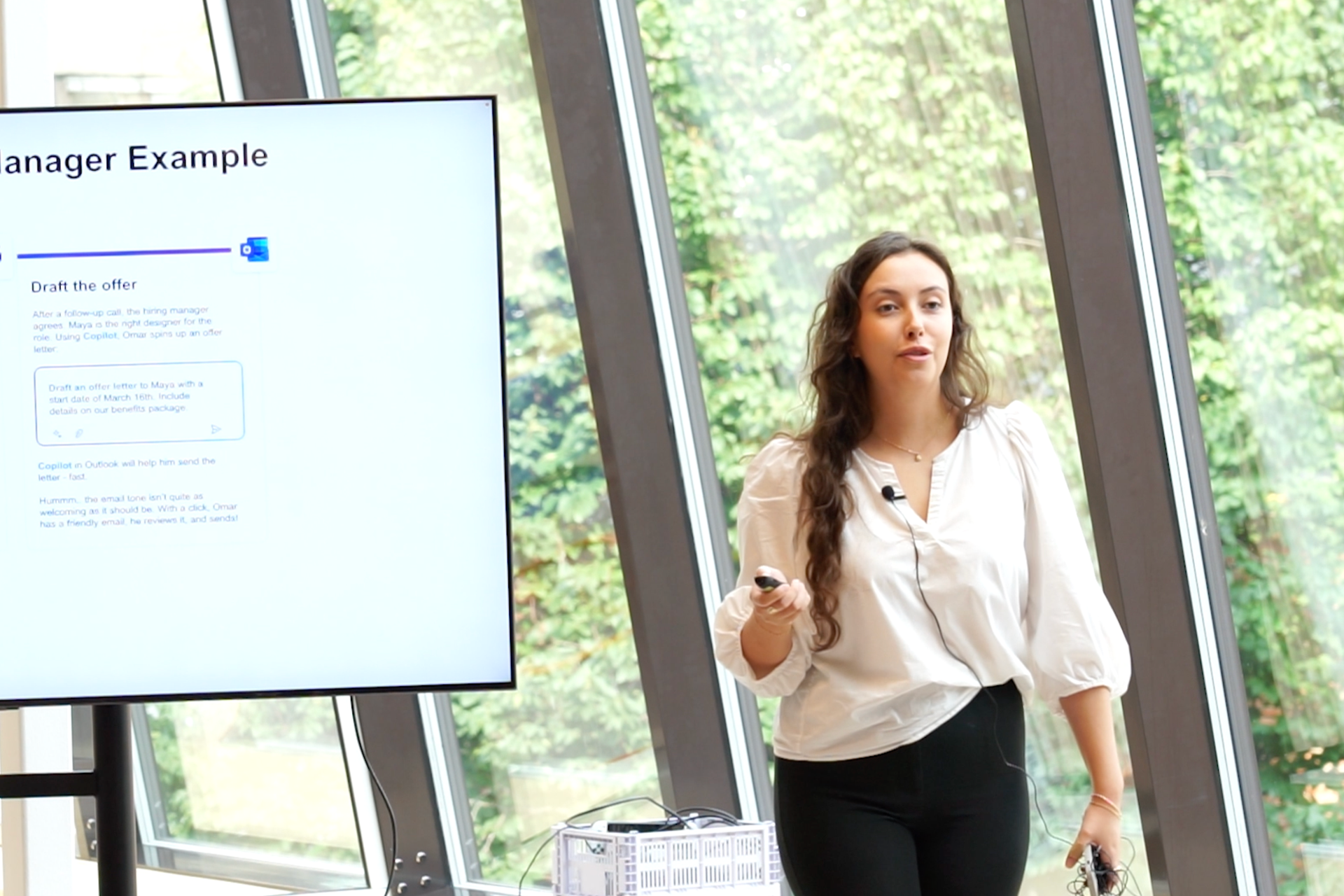 Kvinne presenterer på et seminar om "Prompt Engineering", viser en skjerm med "Recruiting Manager Example".