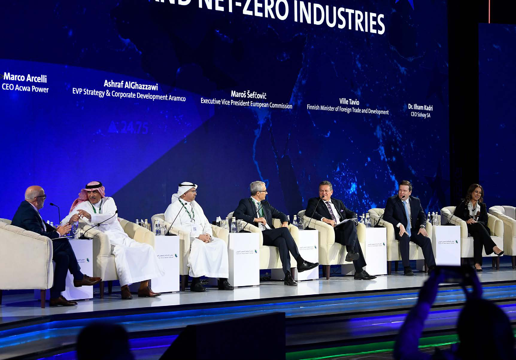 Panel discussion on stage at the Saudi-EU Investment Forum, with speakers seated in front of a large screen.