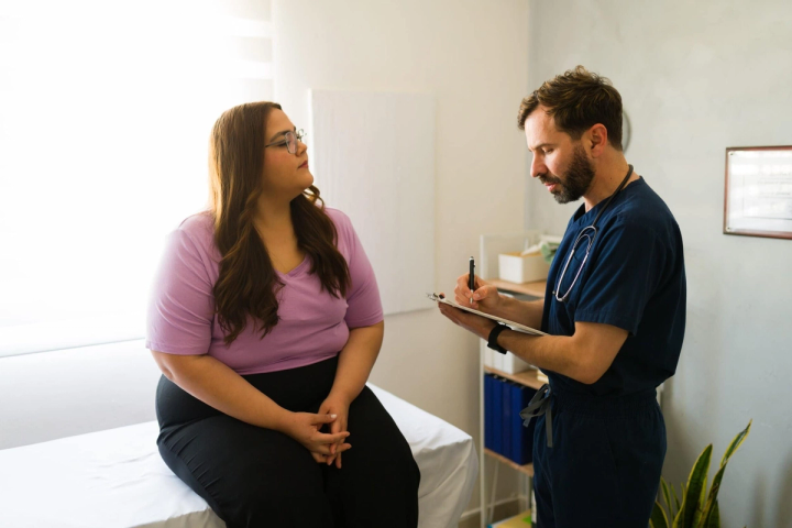 Patient talking with a clinician in an exam room