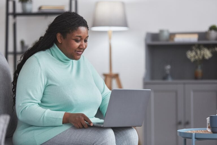 Woman working on a laptop at home