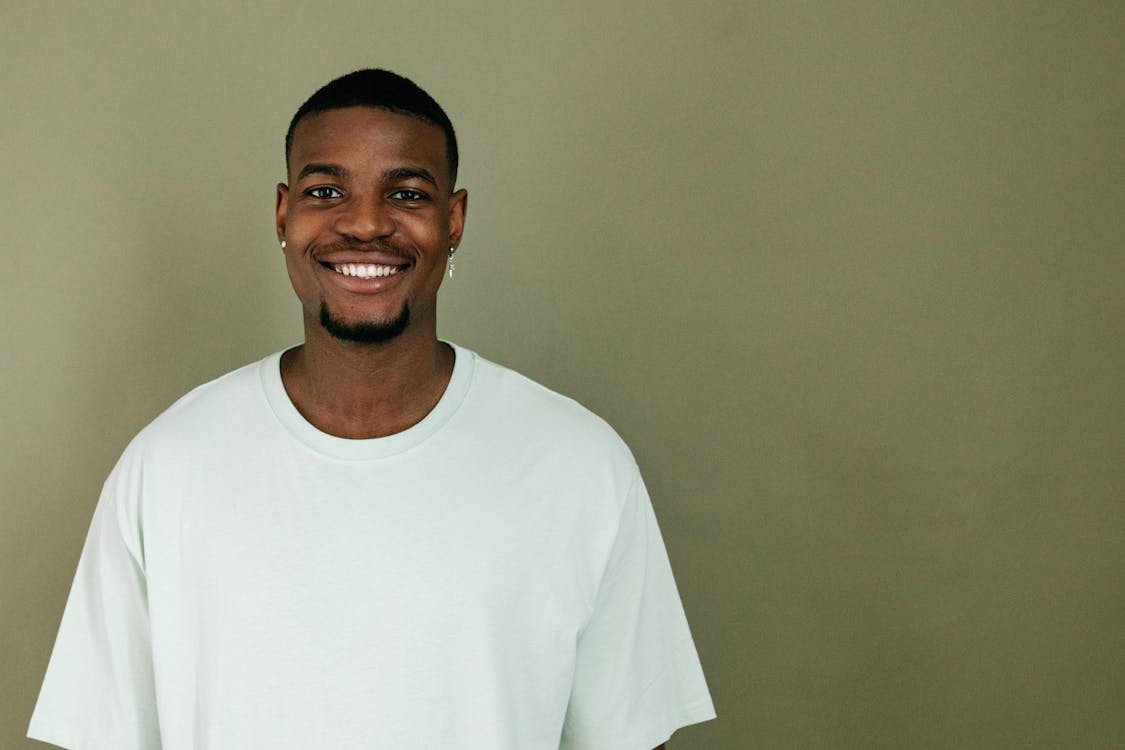 Portrait of Scott smiling in a white sweatshirt