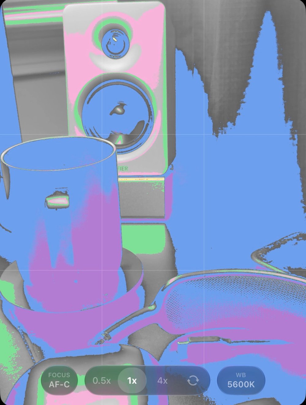 False colour exposure monitoring maps brightness regions across a desk scene.