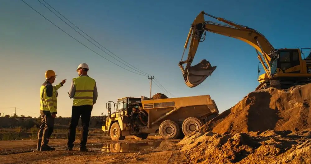 South Carolina contractor reviewing construction plans at a Charleston area job site where general liability and workers compensation insurance may be required.