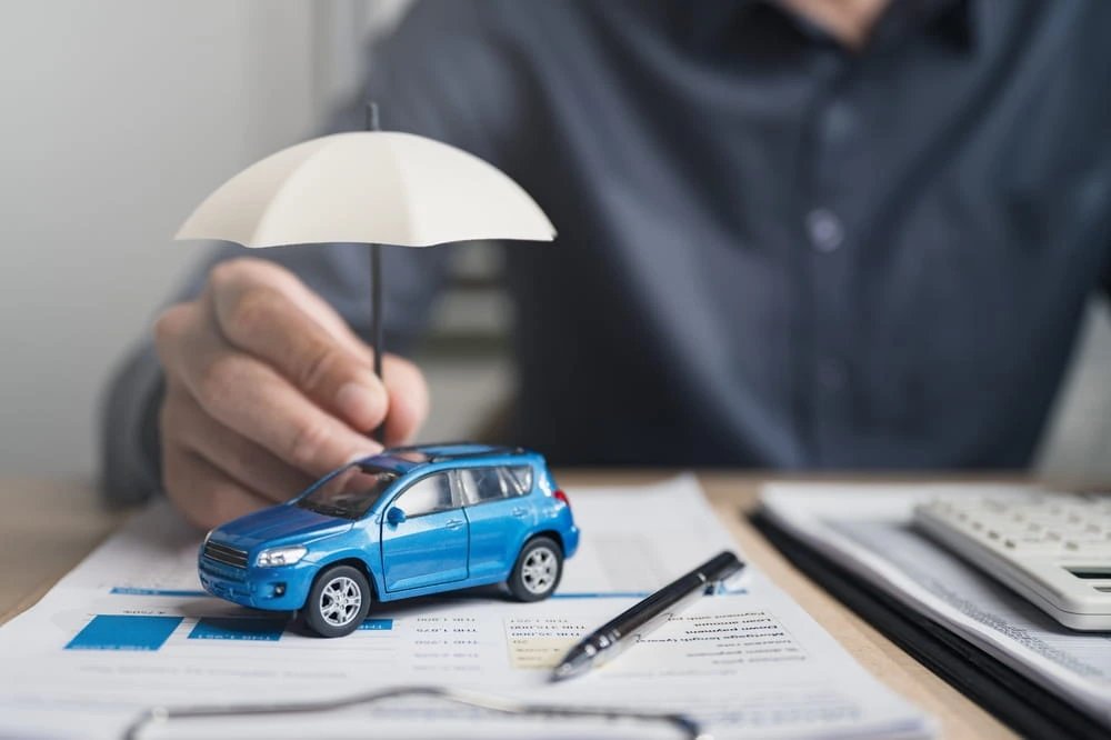 auto insurance declaration page with toy car and umbrella