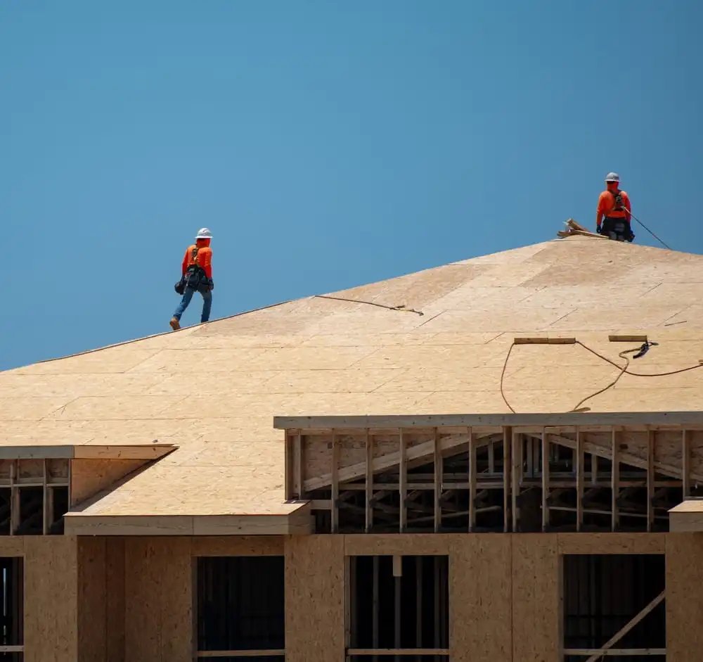 Roofing contractor working at height on a Charleston SC area residential project where workers compensation insurance may help cover workplace injury claims.