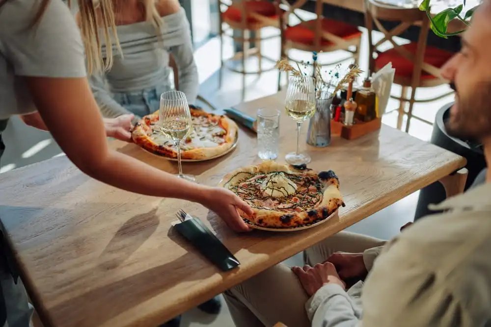 Restaurant server in a Charleston SC dining room where general liability and workers compensation insurance may help protect against customer and employee injury claims.
