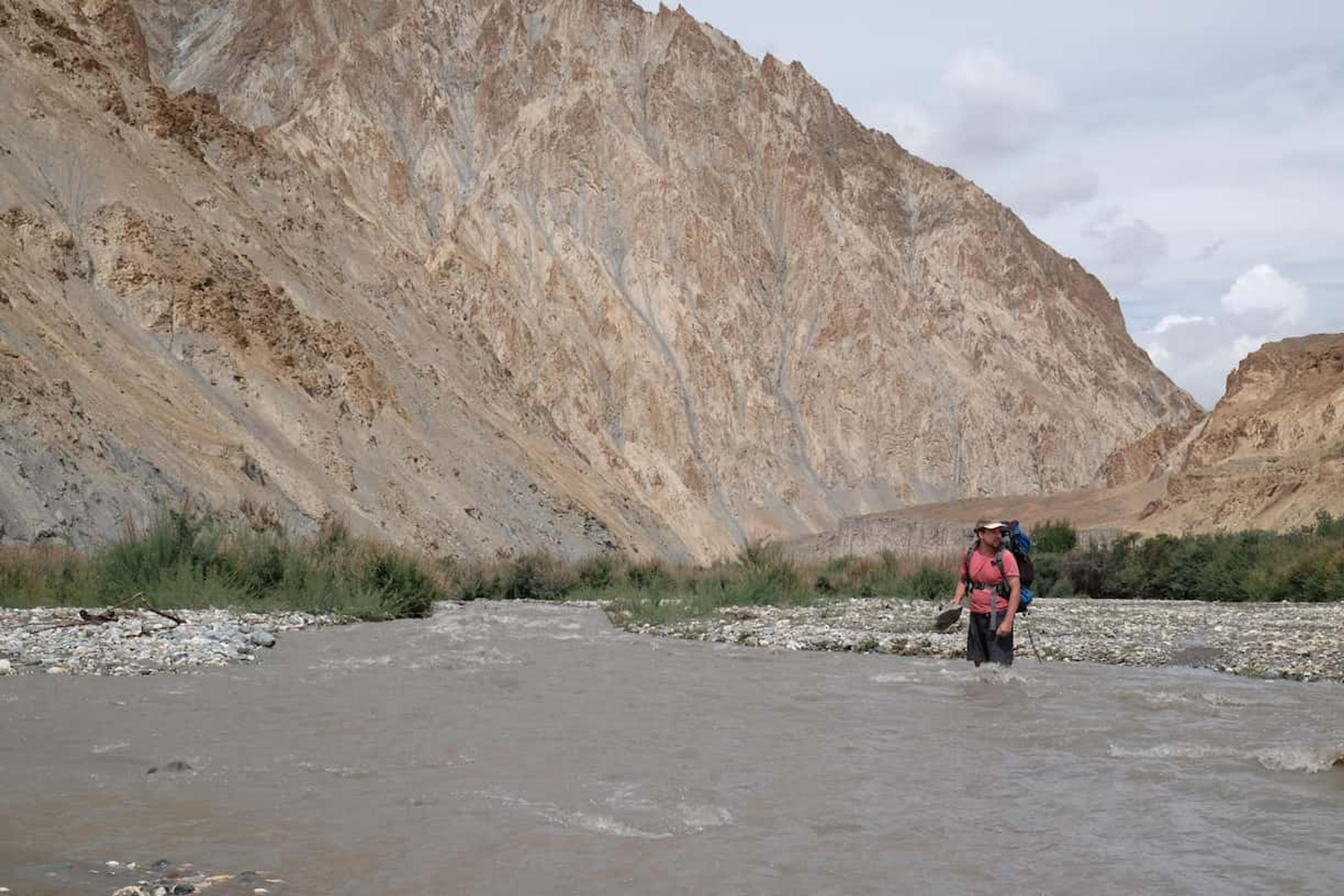 wading through the river to get pack on the path