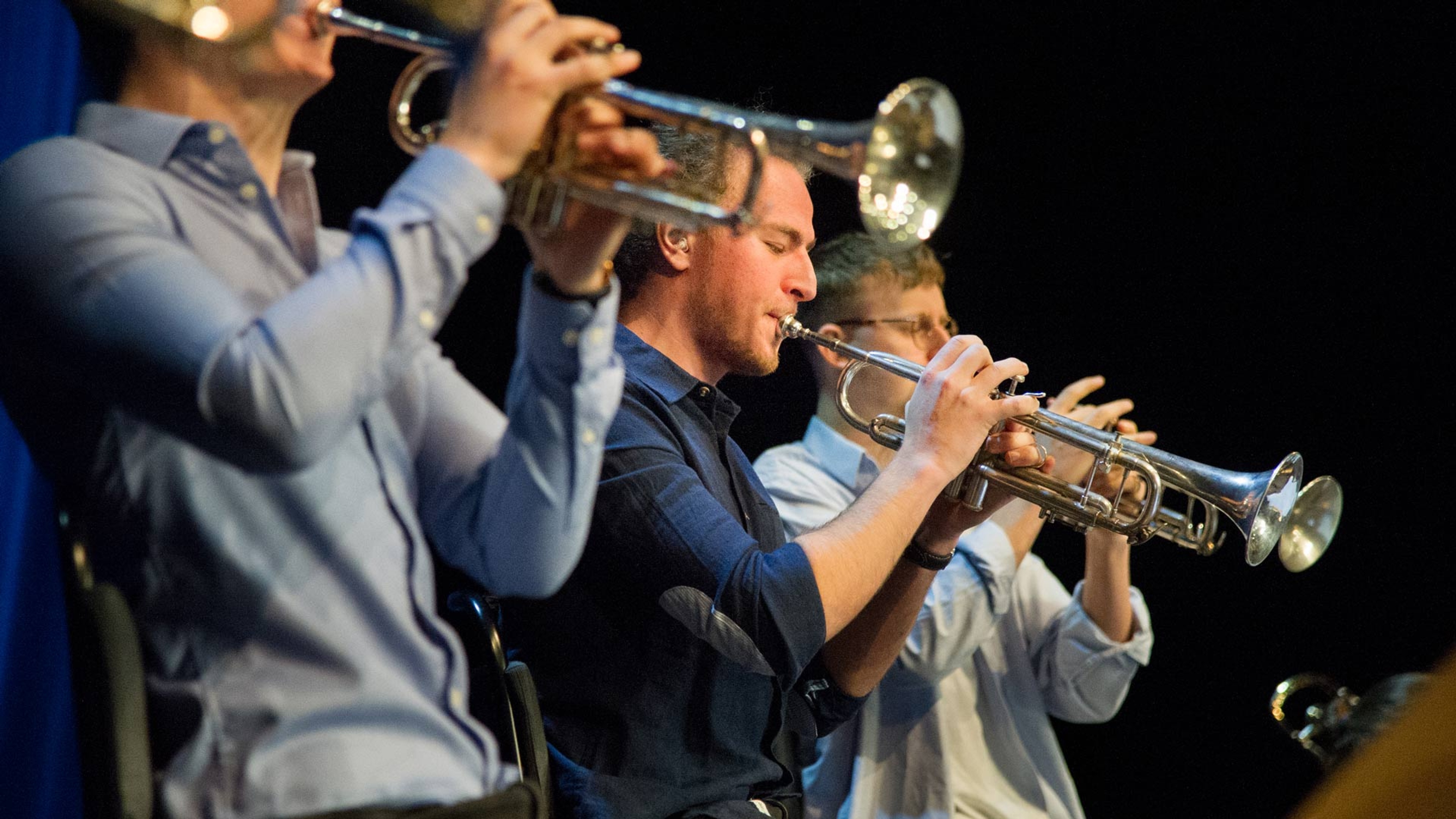 Tre trumpetare i Next Generation Big Band som spelar på sina instrument.