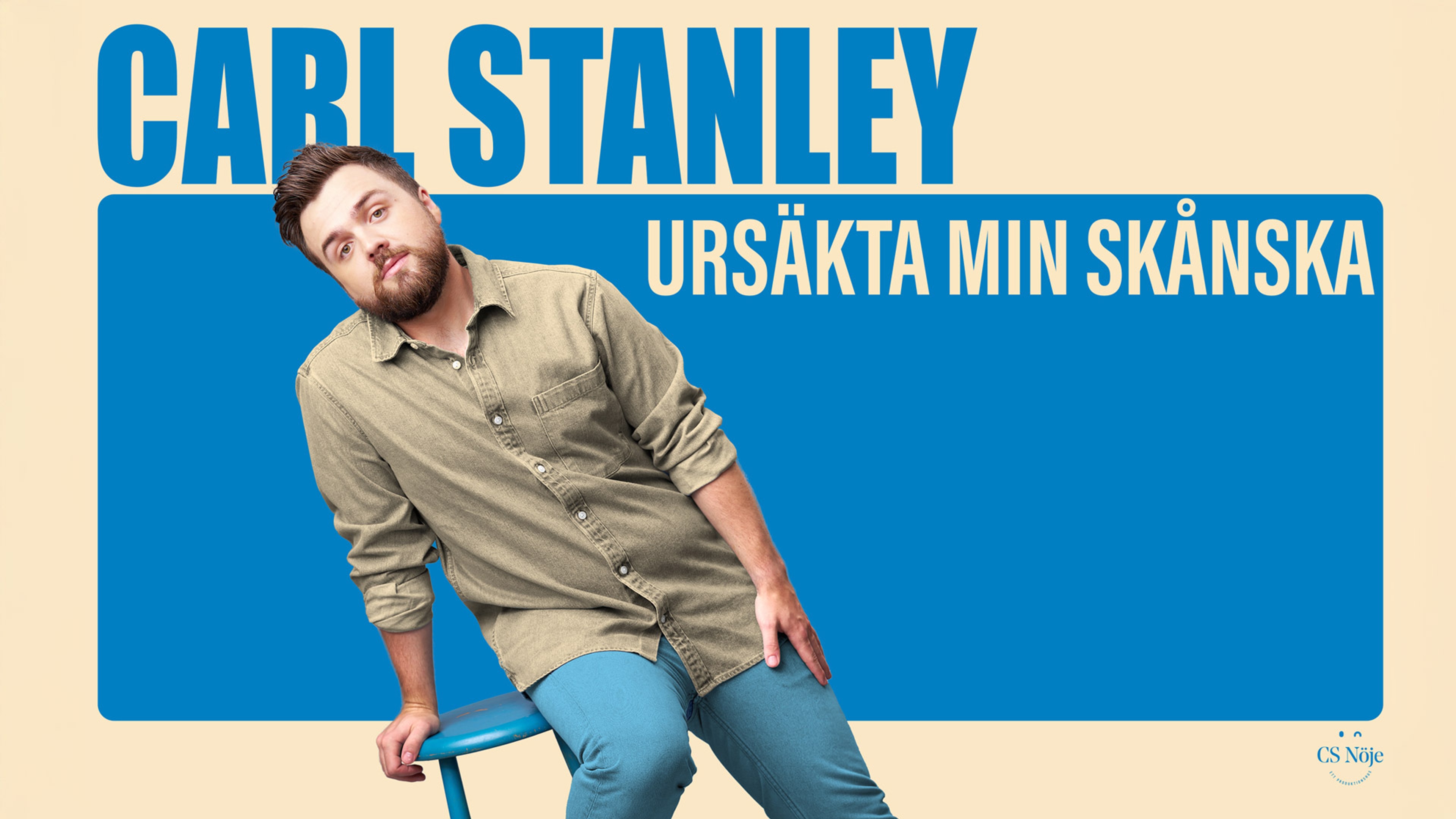 Carl Stanley på en blå stol. Text: Ursäkta min skånska.
