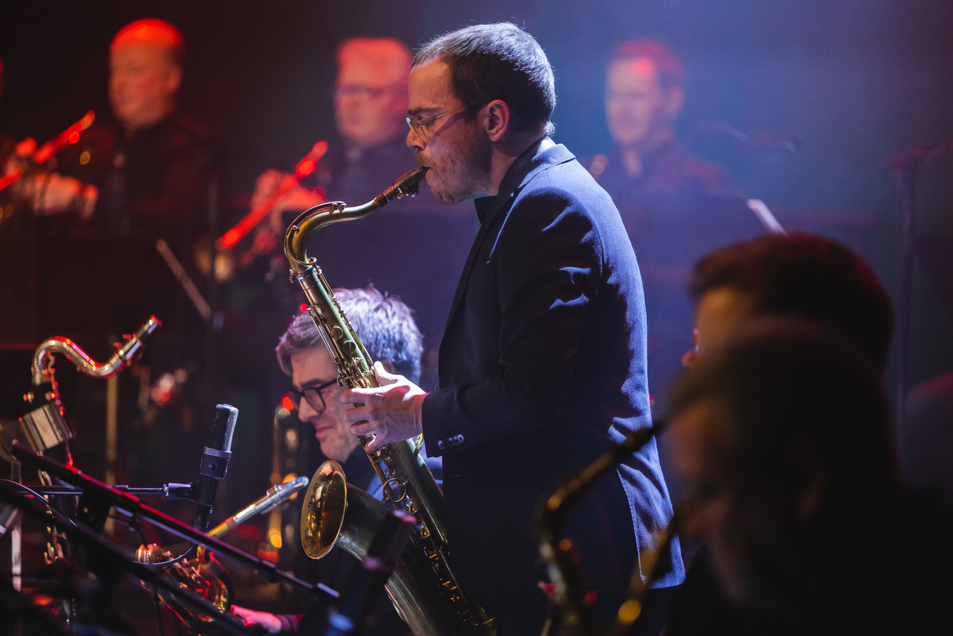 Bohuslän Big Band during a concert. A saxophonist playing a solo in the foreground.