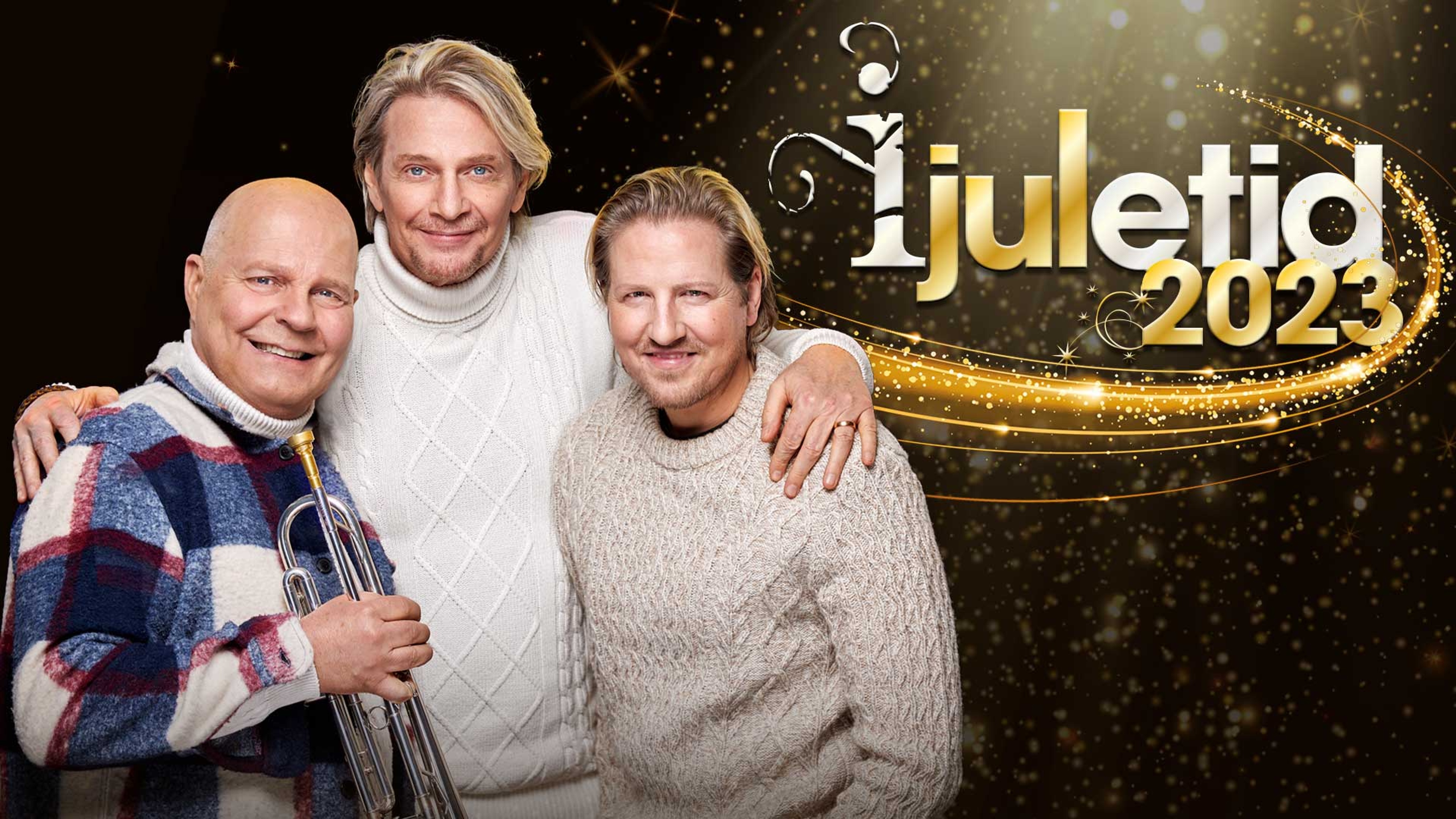 Magnus Johansson, Tommy Nilsson och Marcos Ubeda står och håller om varandra  och ler in i kameran framför en mörk, glittrande bakgrund. Text: I juletid 2023