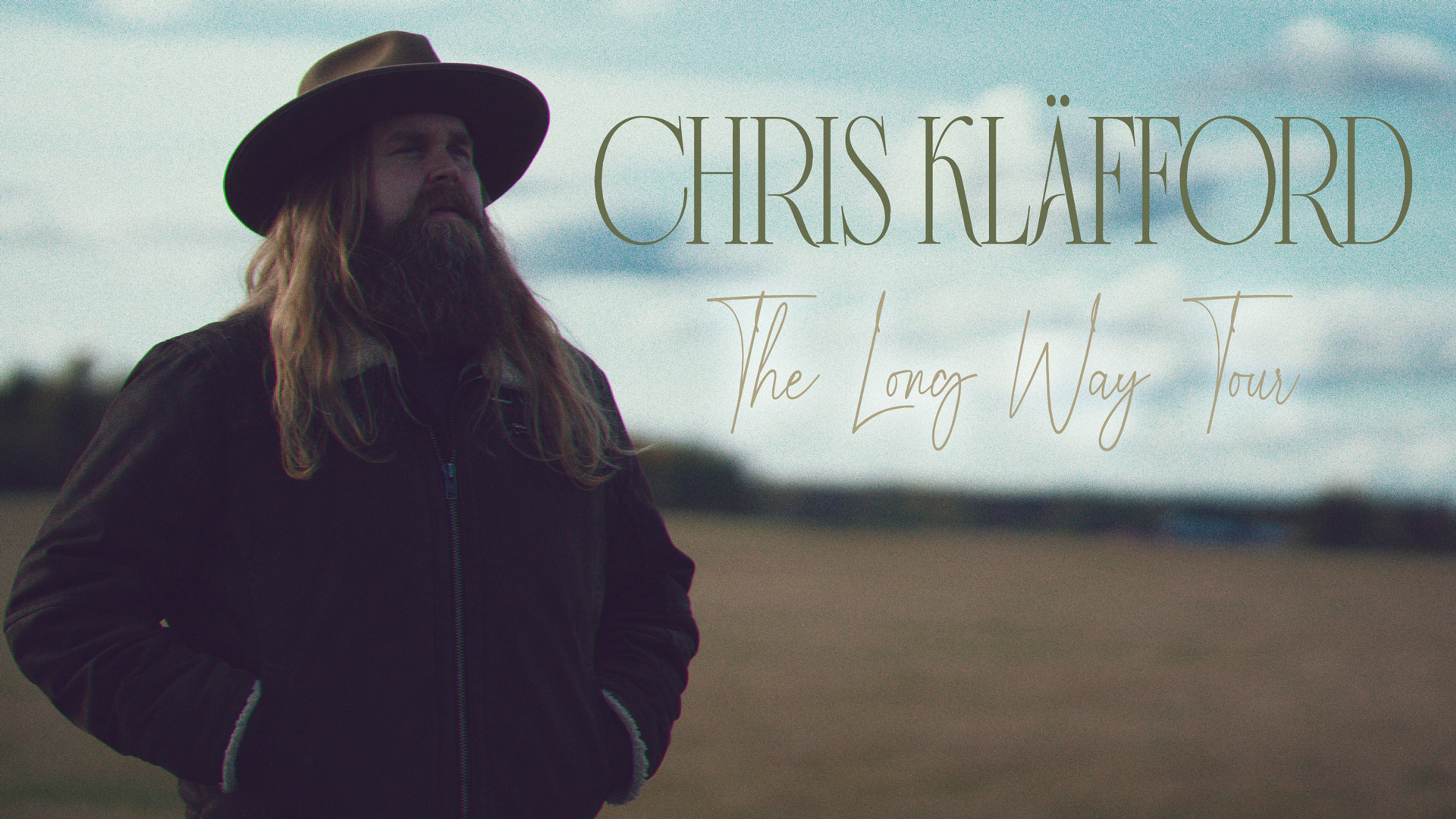 Chris Kläfford vid ett fält. Text: Chris Kläfford, The Long Way Tour.