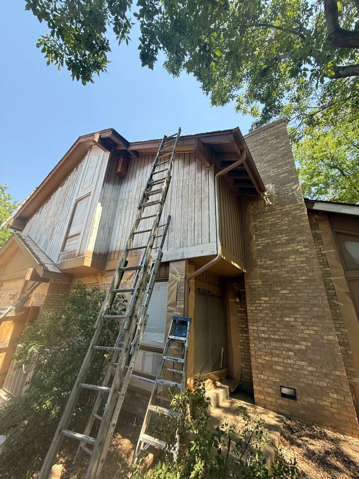 Tall extension ladder on house exterior — Denver