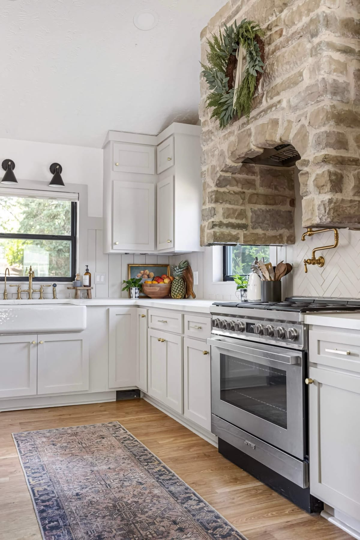 Refinished white kitchen cabinets with brass hardware