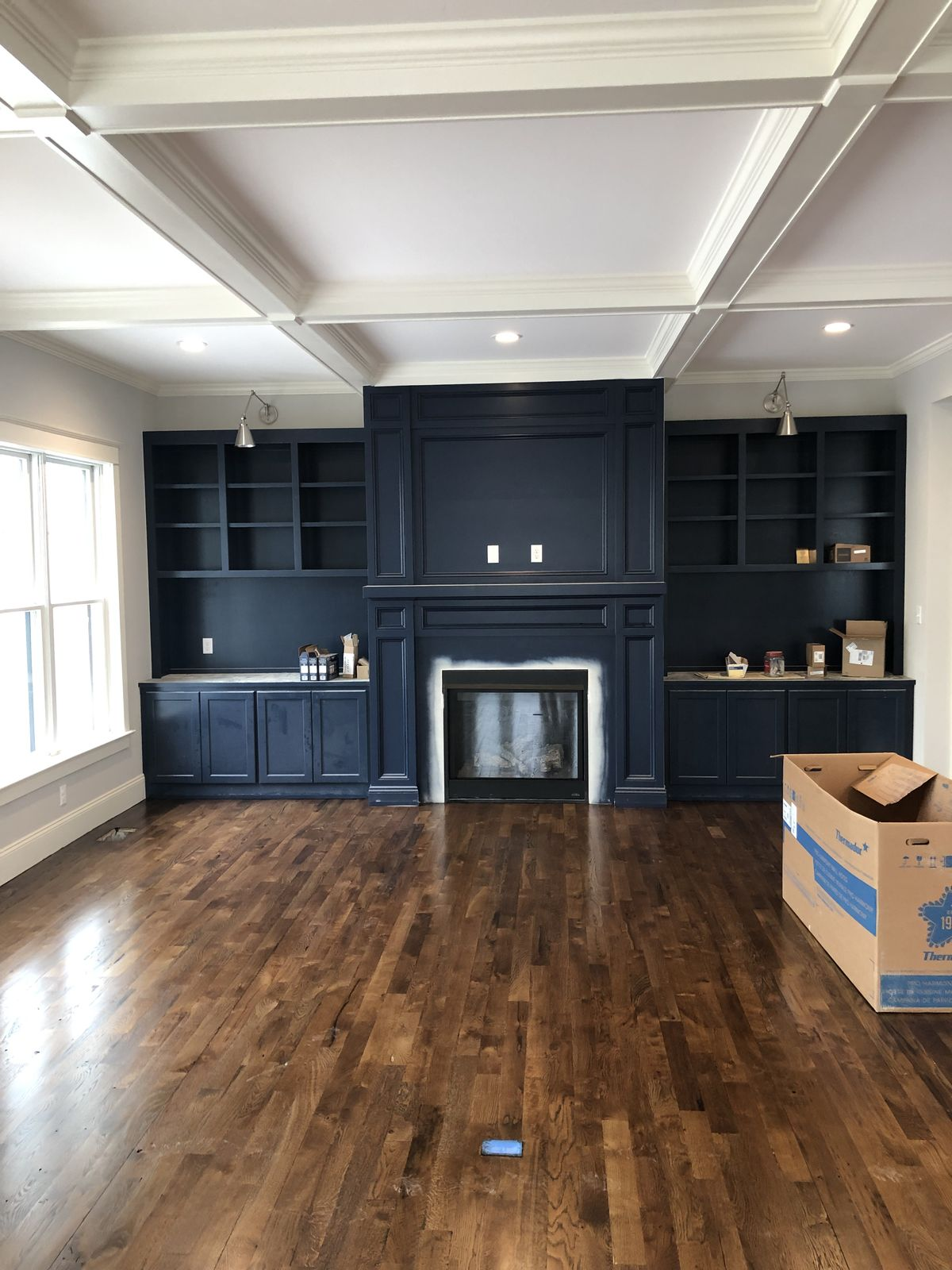 Deep navy accent wall with crisp white coffered ceiling