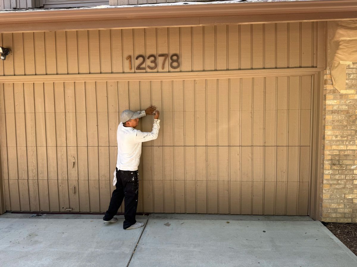 garage door man painting — Denver