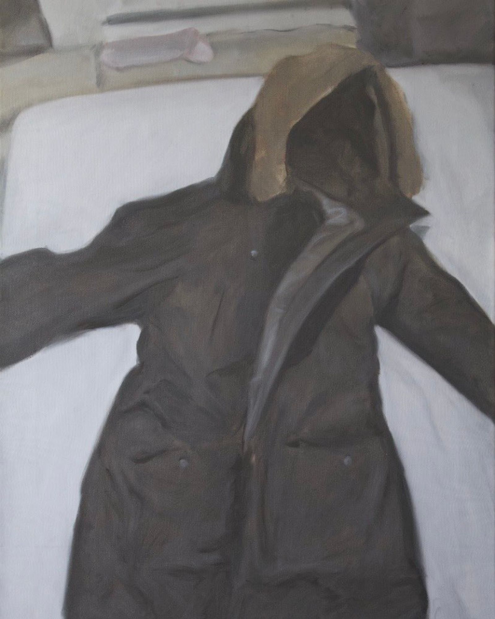Hooded coat on bed