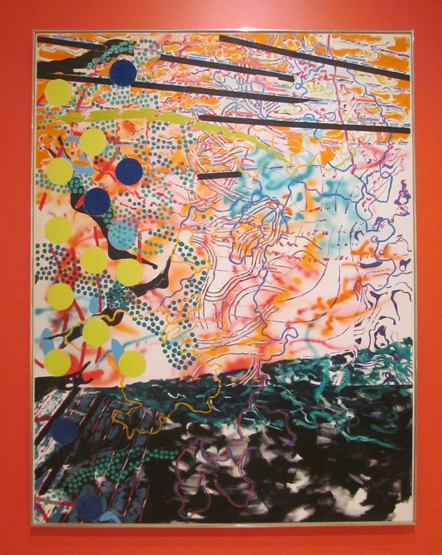 A photo image of Nancy Grave's painting called Distract. It is a modernist style painting of sky, ground and on the right side a tree. There are many lines and shapes of different colours woven through to depict a busy visual space.
