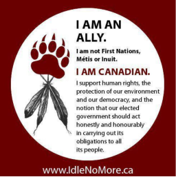 A white circle within a red square. In the white circle, there is a red bear paw, black feathers, and text that reads: “I am an ally. I am not First Nations, Métis or Inuit. I am Canadian. I support human rights, the protection of our environment and our democracy, and the notion that our elected government should act honestly and honorably in carrying out its obligations to all its people. www.IdleNoMore.ca.” 