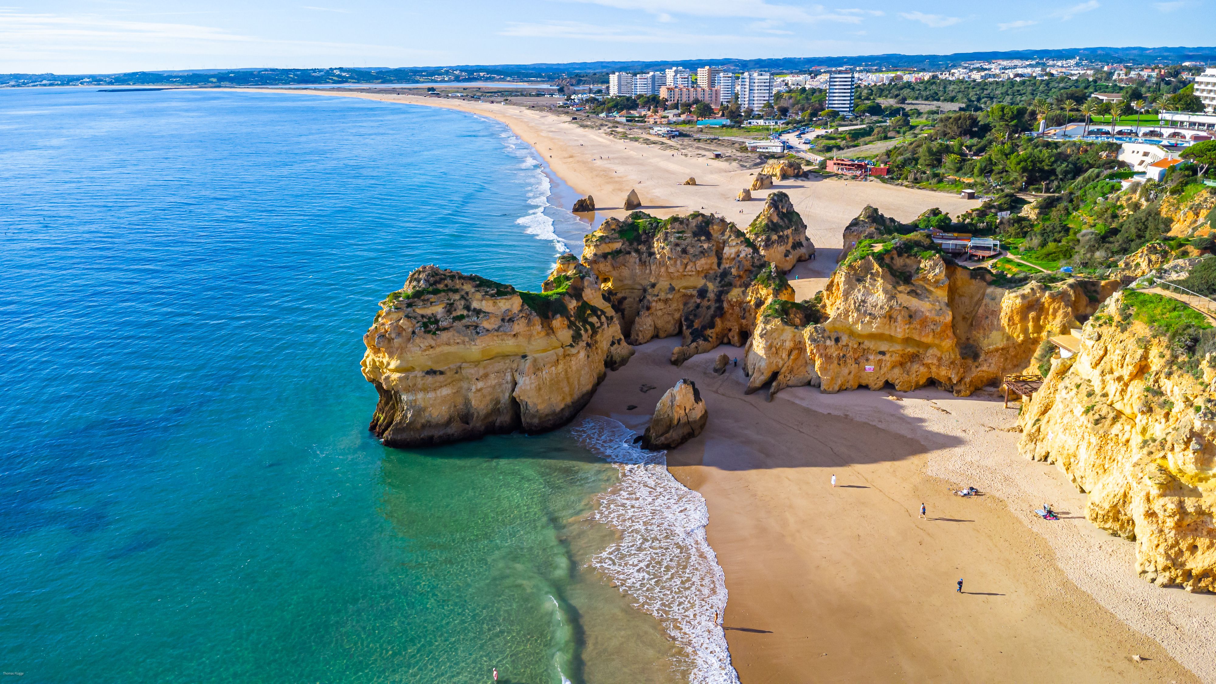 Sandy beach and deep blue sea in Alvor, Algarve, Portugal