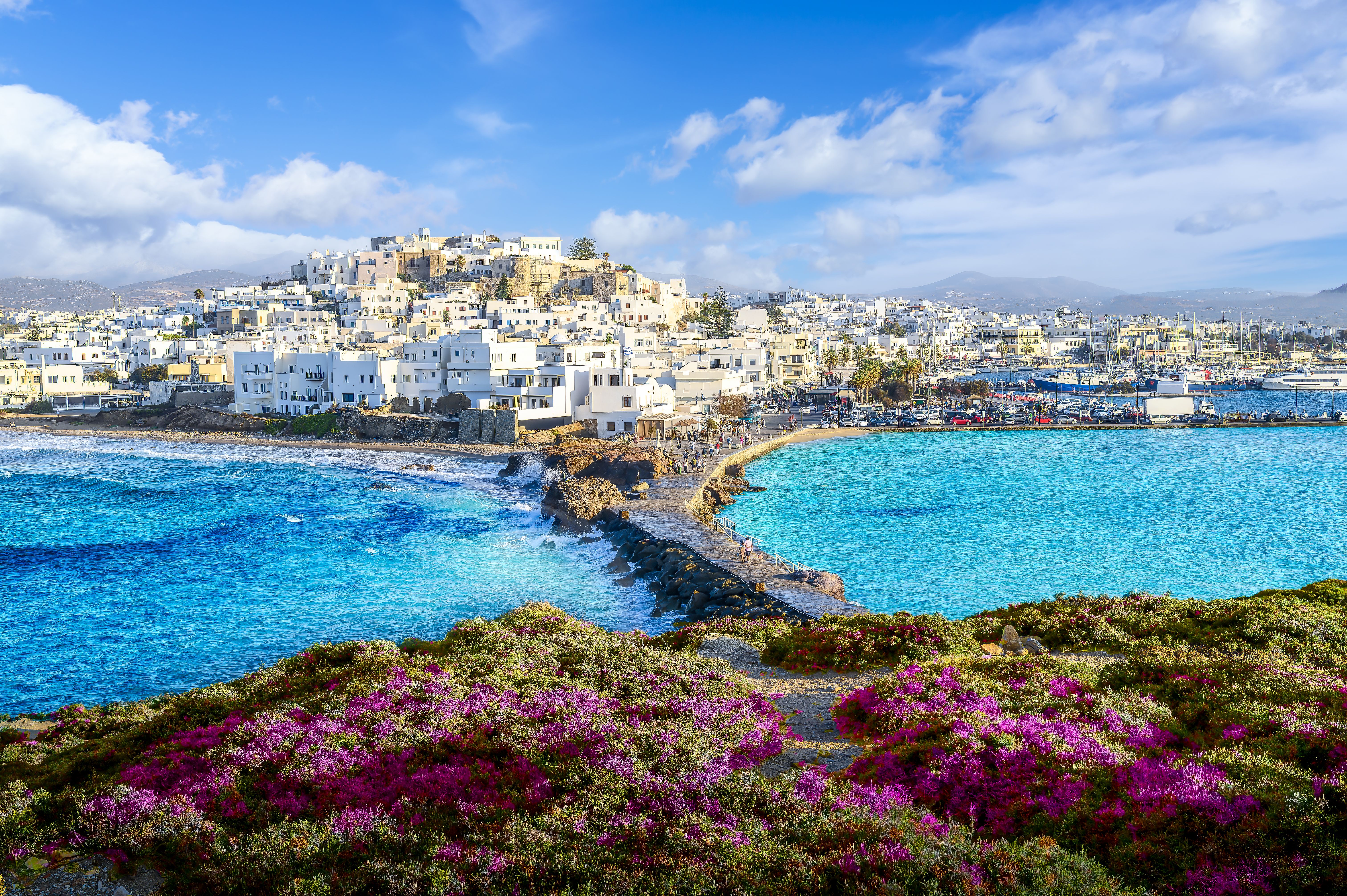 A view across a coastal walkway of Chora town on Naxos island, Greece
