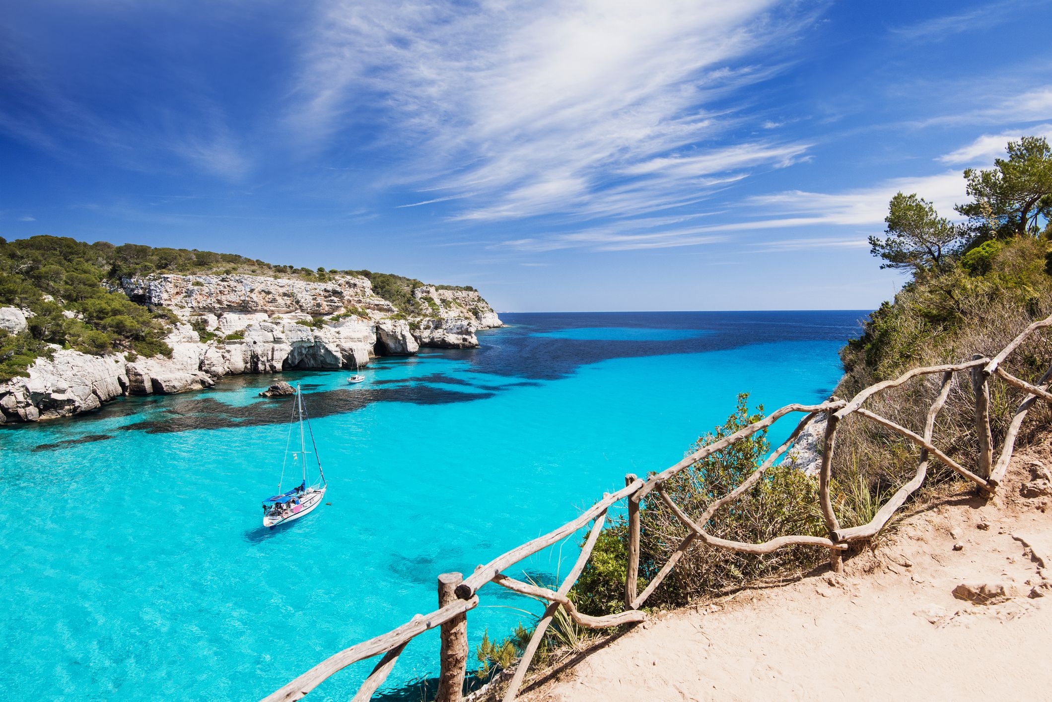 Beautiful bay with a sailing boat in Menorca, the Balearic Islands