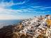An aerial view over the clifftop town of Oia in Santorini, Greece