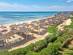 View of Hammamet beach in Tunisia with straw umbrellas and sun-loungers
