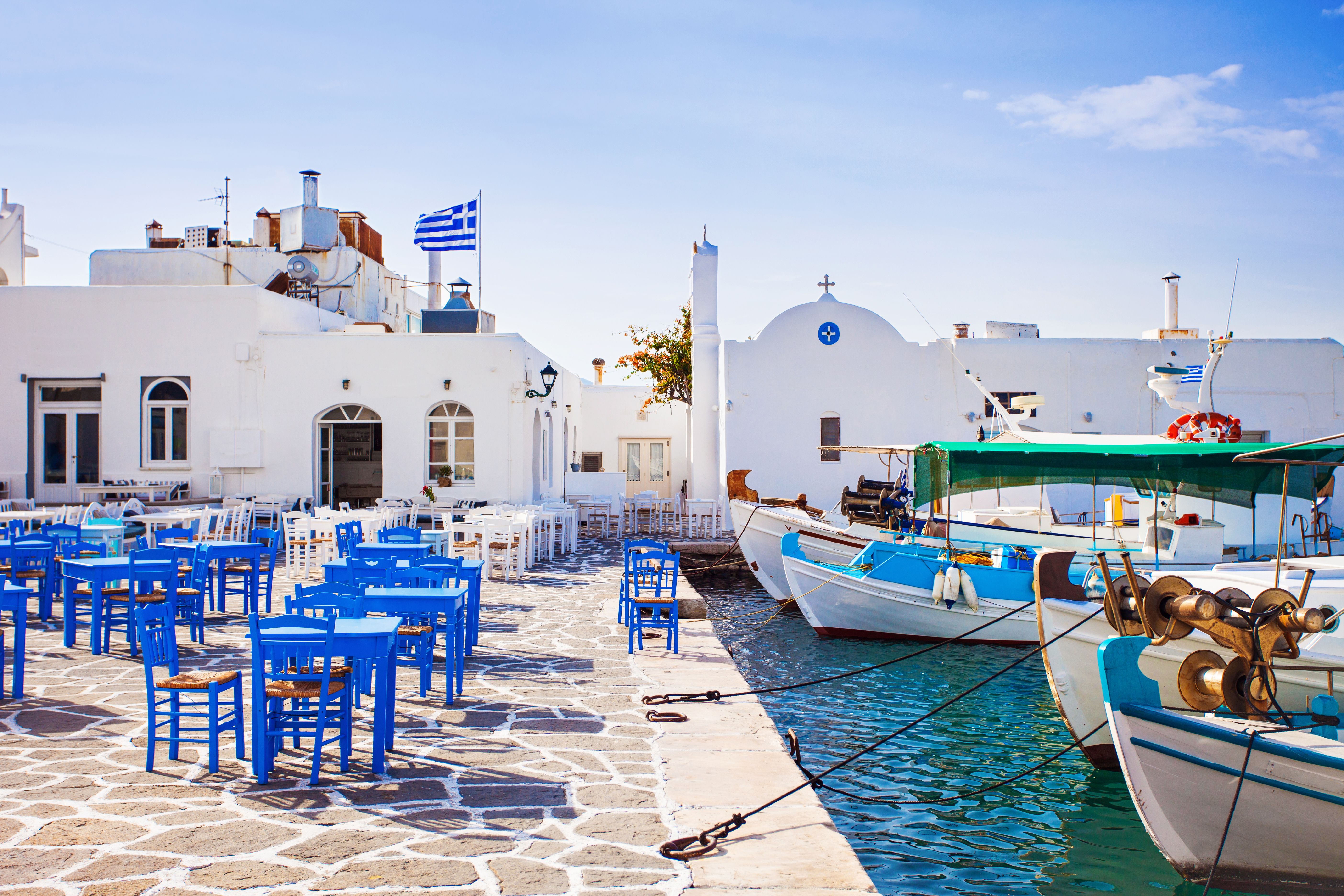 Naousa village on Paros island with harbour side restaurants tables and chairs