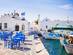 Naousa village on Paros island with harbour side restaurants tables and chairs