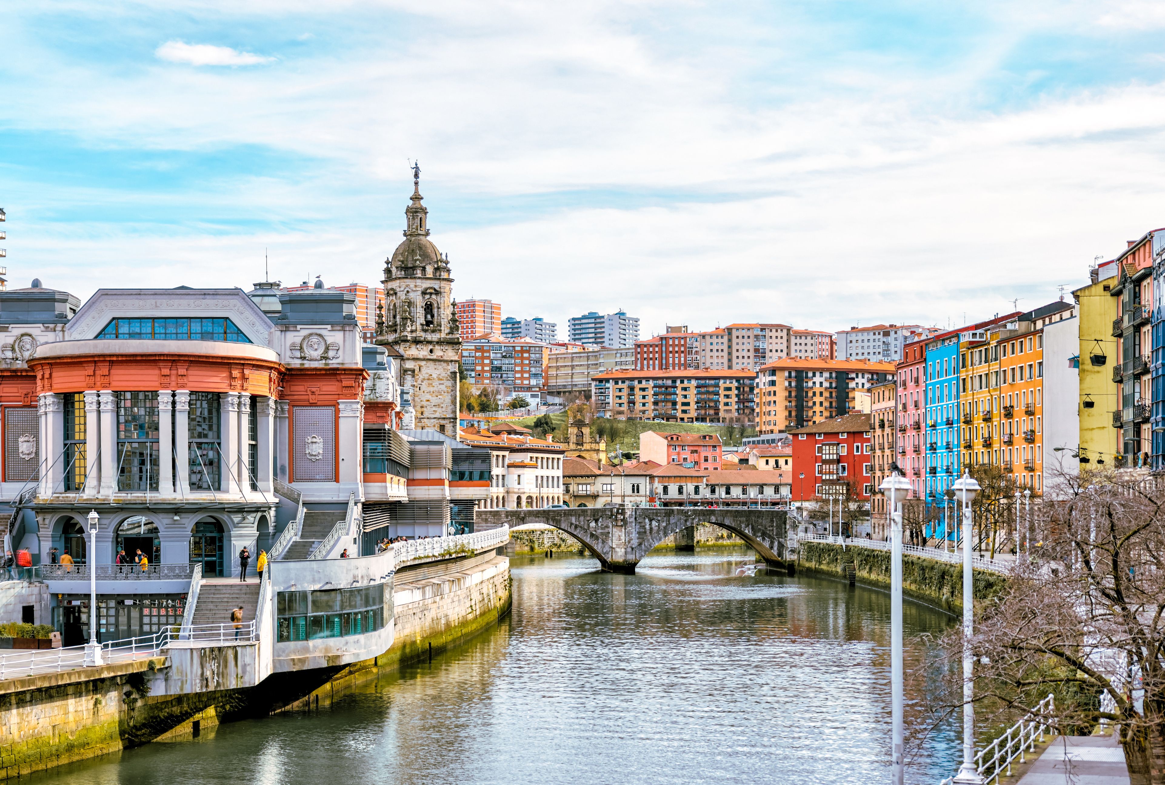 A view down the Nervion River in Bilbao, Spain, lined with colourful buildings