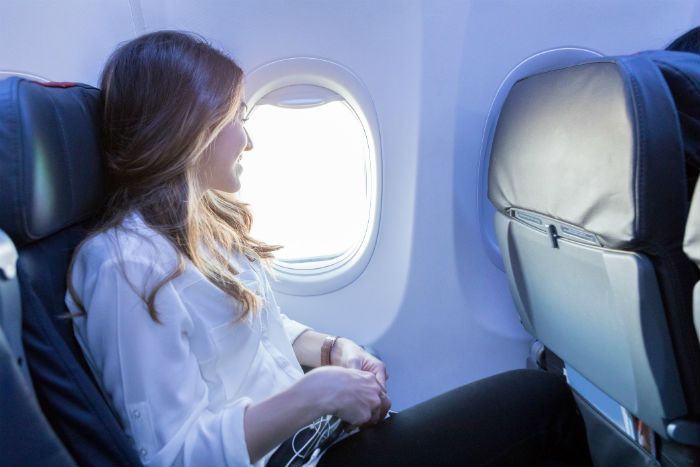 Woman Sat On Aeroplane Window Seat