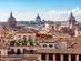 A view over the terracotta rooftops of Rome with the dome of St. Peter's Basilica in the background