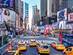 Yellow taxi cabs and bright digital billboards in Times Square, New York City